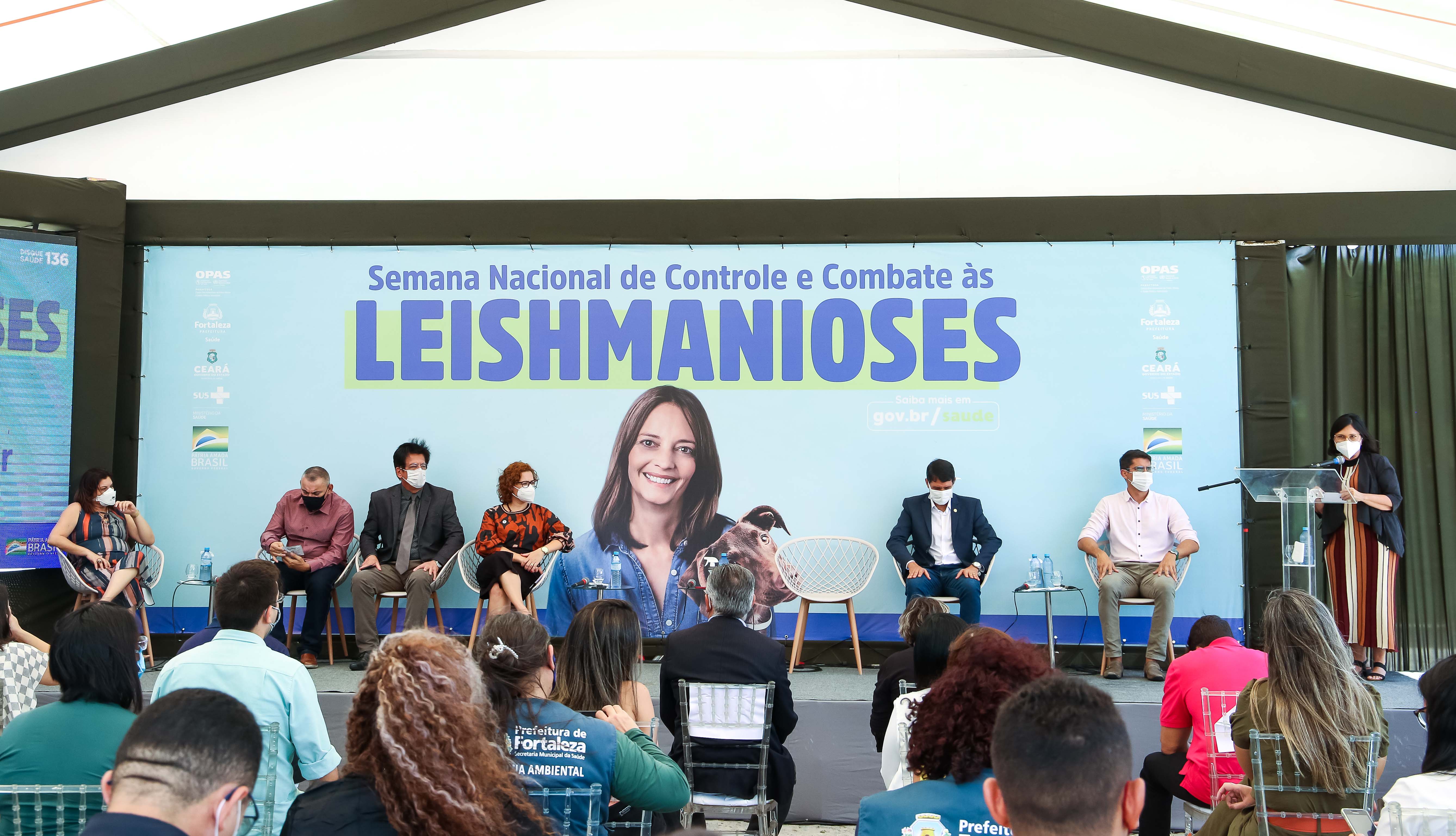 a foto mostra um palco com um grupo de pessoas